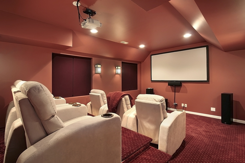 Luxurious theater in upscale home with red walls